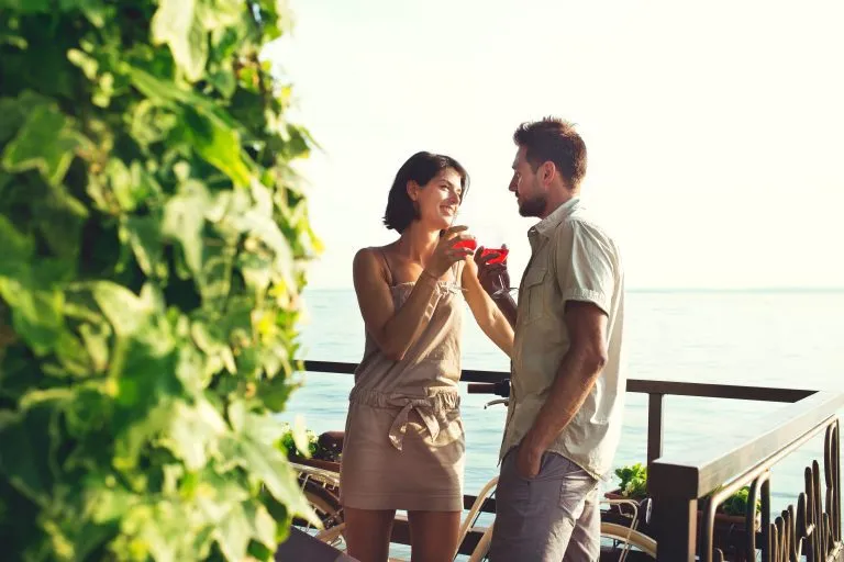 couple in love having spritz time with lake view